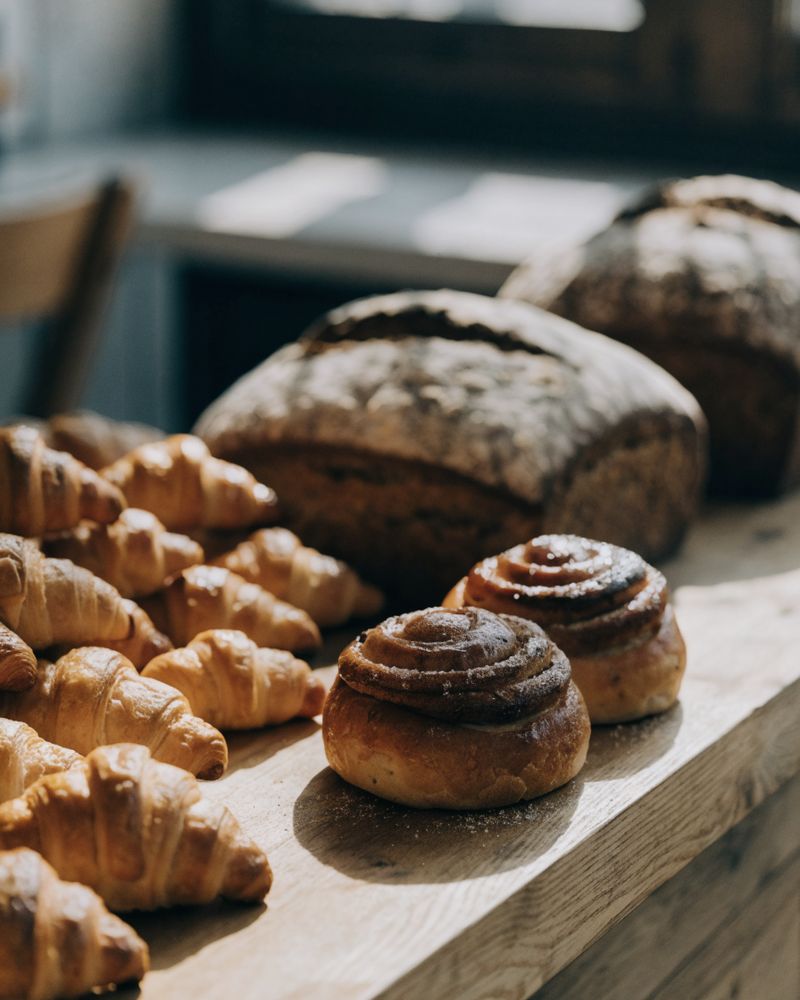 Fresh croissants and sourdough on a bakery counter